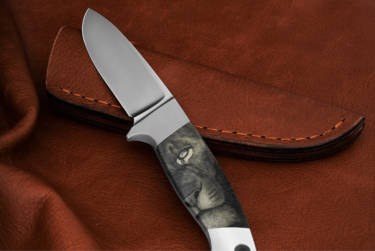 Das passende Messer mit Scrimshaw- Gravuren und ein handgearbeiteter Lederkoffer gehören mit zum Ensemble.